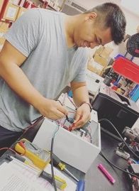 employee working with paint booth control panel